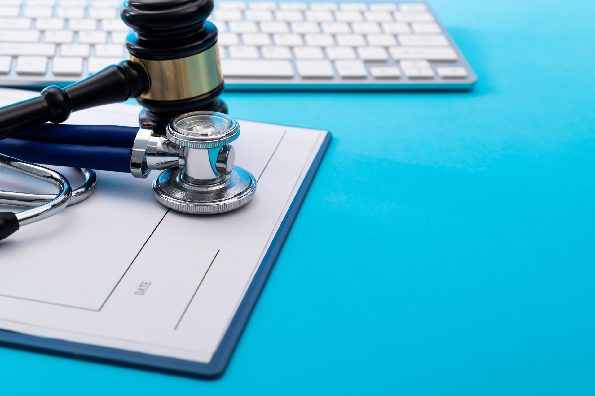 Gavel and stethoscope on blue background